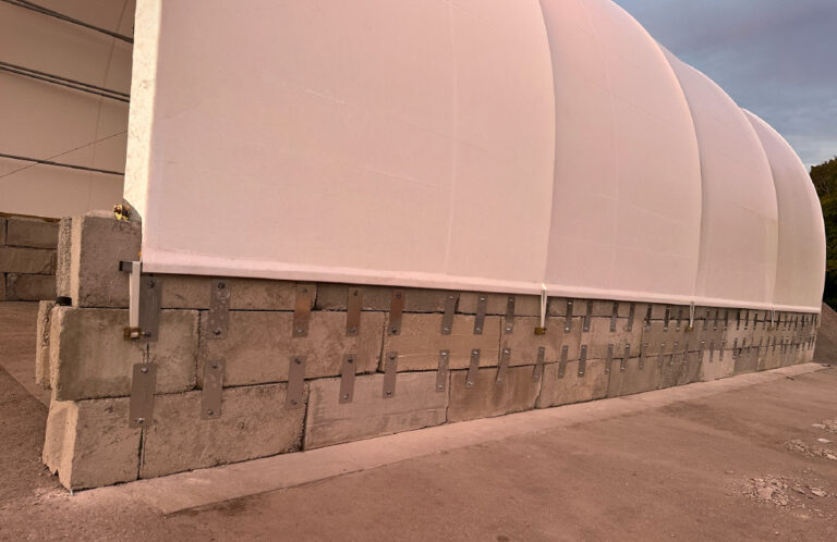Side profile of an Accu-Steel Advantage salt storage building on a concrete block foundation.